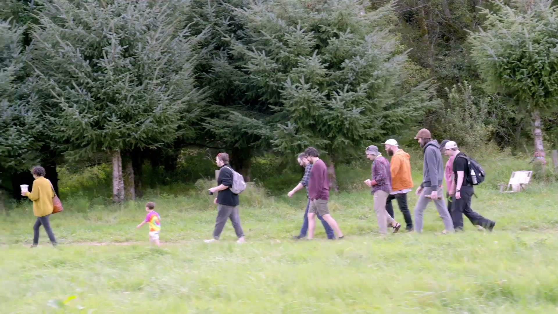 People walking together through a green field at Cascade Camp